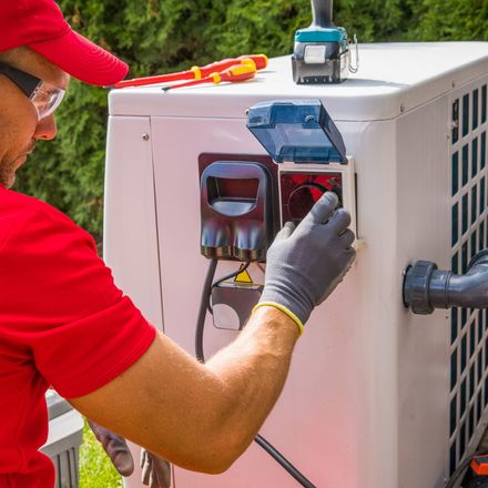 Dunn Right HVAC LLC | a man in a red shirt is working on a machine.