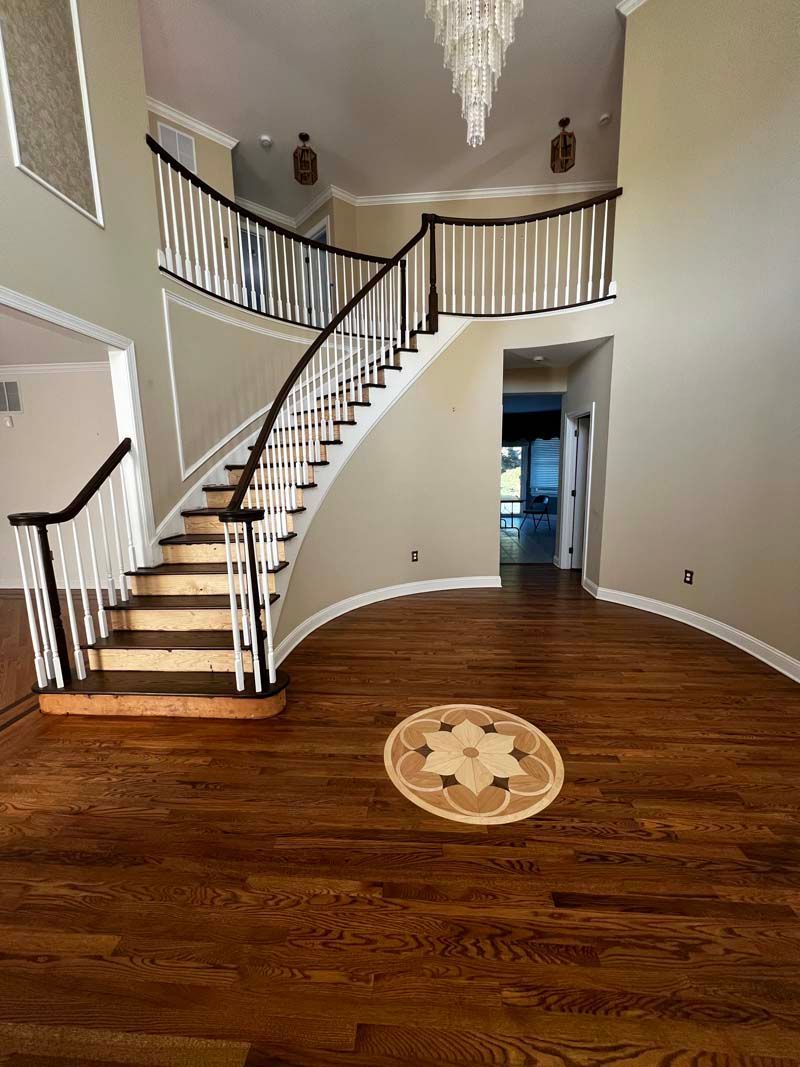 There is a curved staircase in the middle of the room.