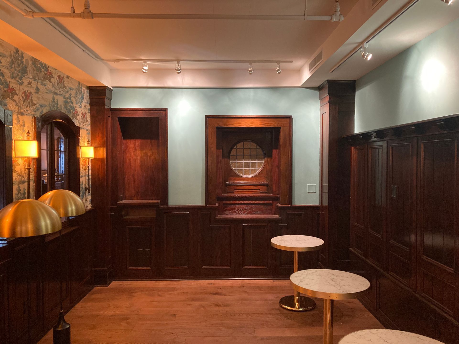 A room with wood paneling and two tables in it