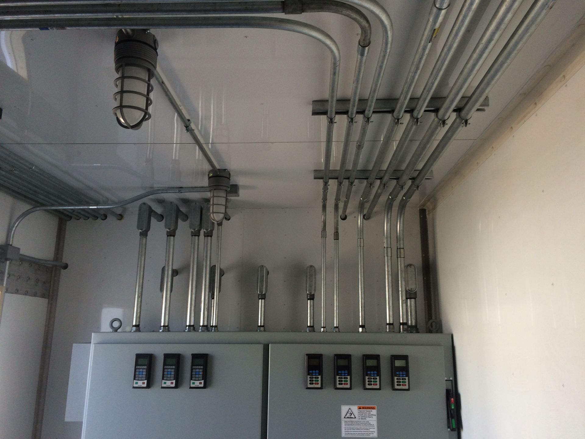 A room with a lot of electrical wires hanging from the ceiling