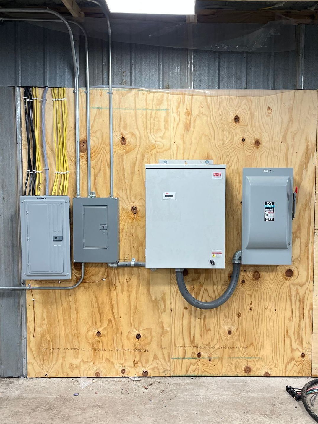There are a lot of electrical boxes on the wall.