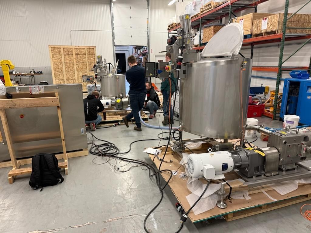 A group of people are working on a machine in a factory.
