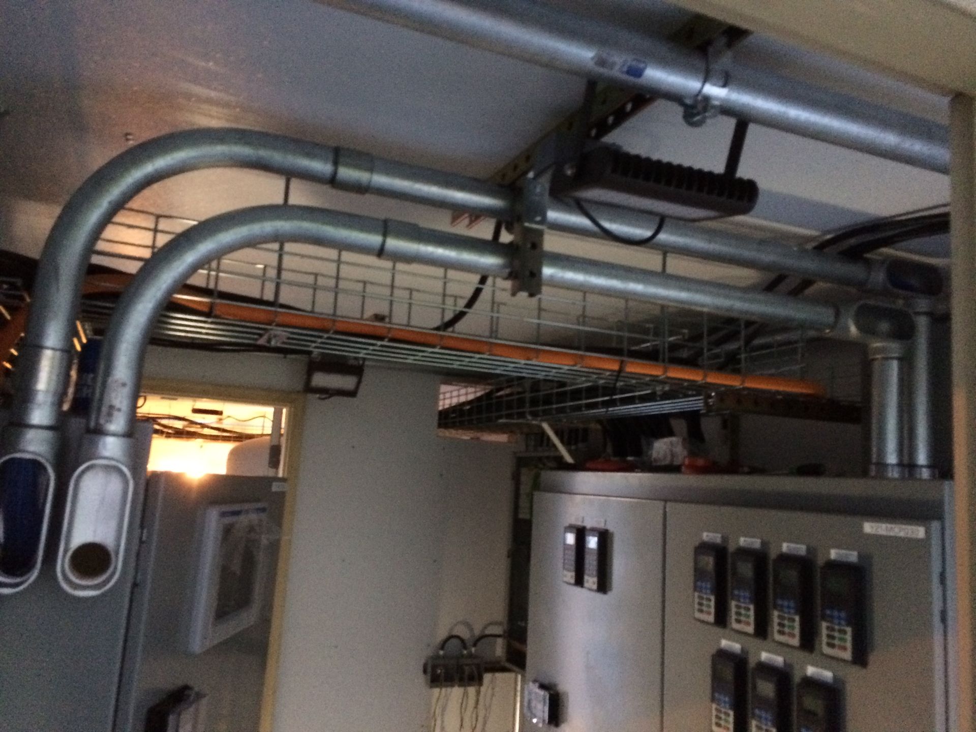 A room with a bunch of wires hanging from the ceiling