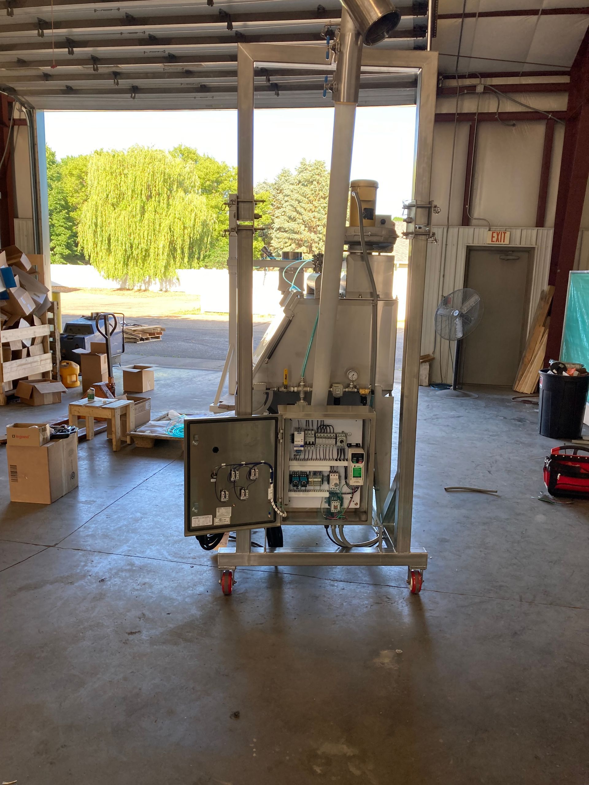 A machine is sitting on a cart in a garage.