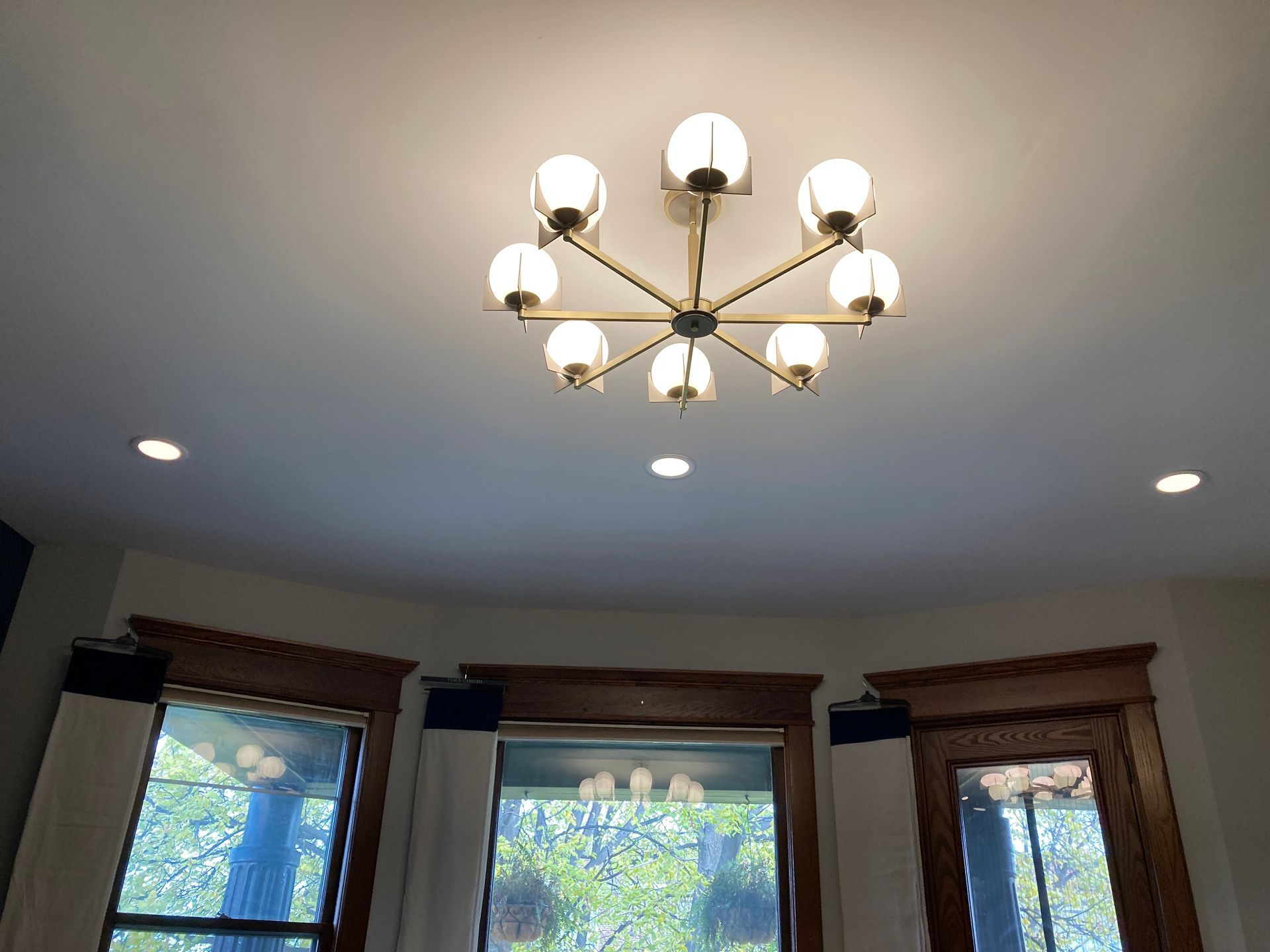 A chandelier is hanging from the ceiling in a living room.