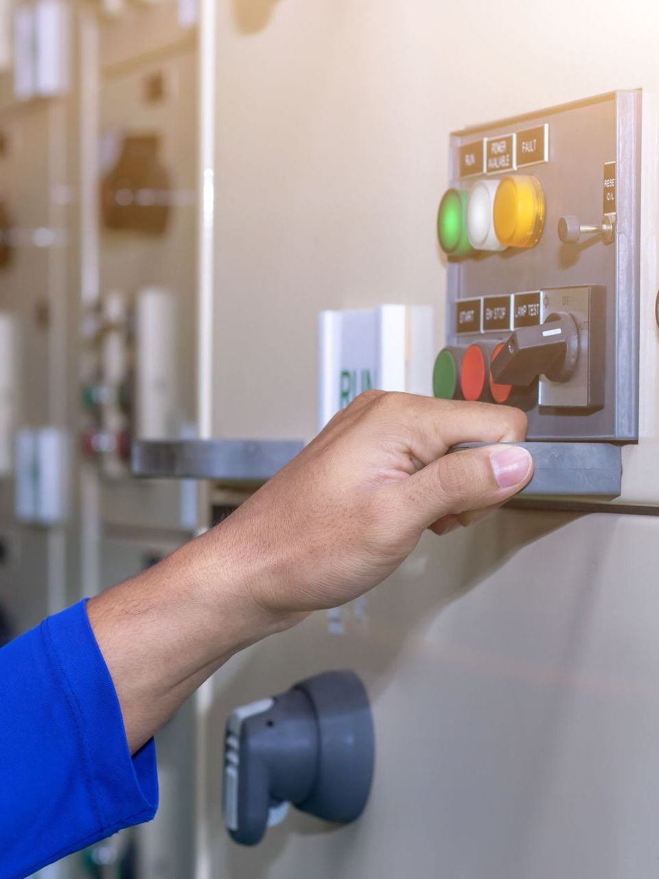 A person is pressing a button on a control panel.