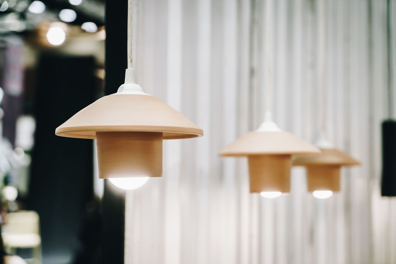 A row of pendant lights hanging from the ceiling in a room.