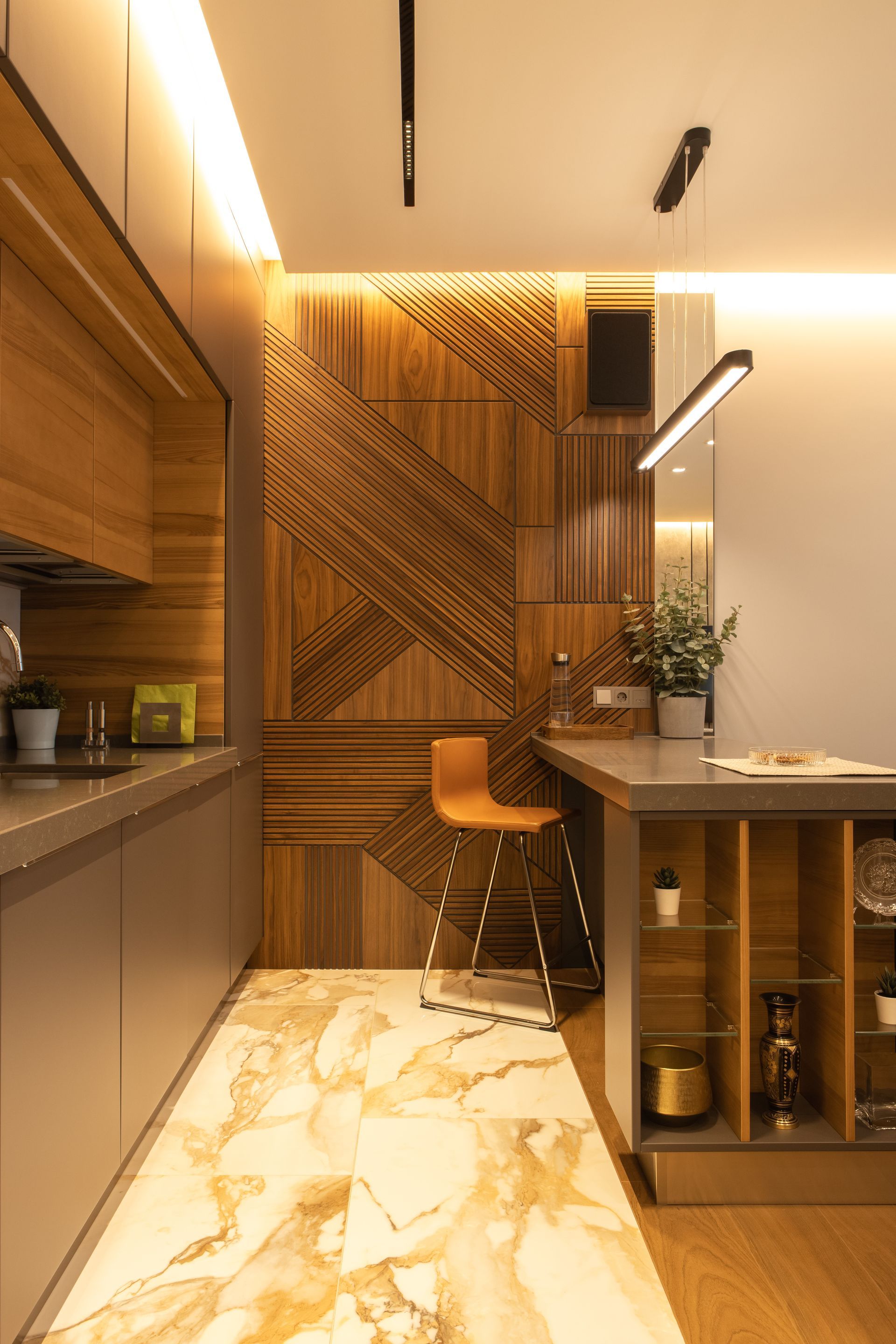 A kitchen with wooden cabinets and a marble floor.