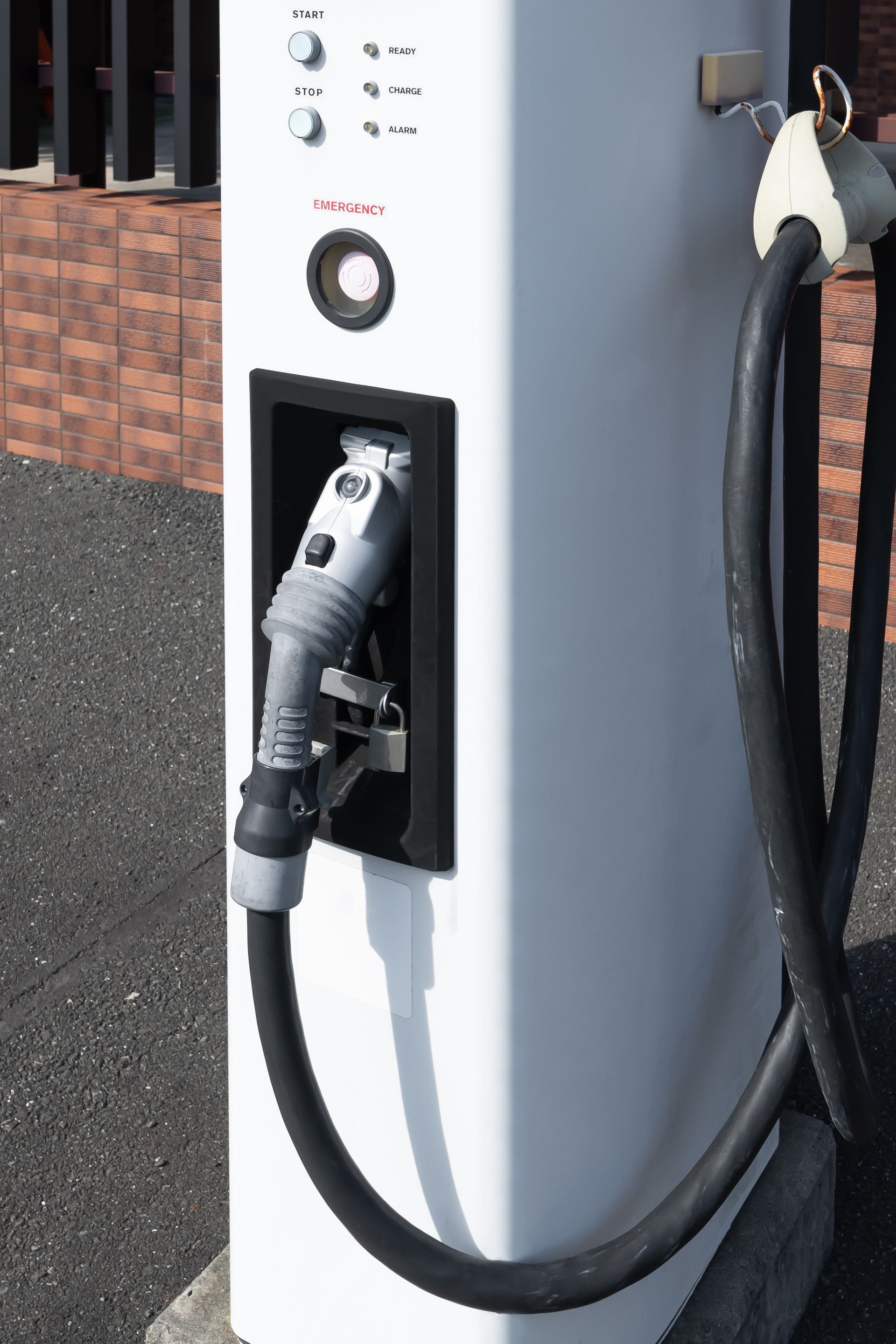A close up of a charging station with a hose attached to it.