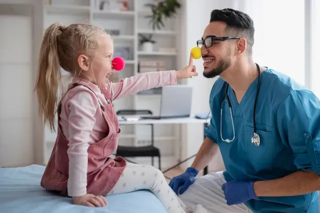 Doctor and child patient with clown noses
