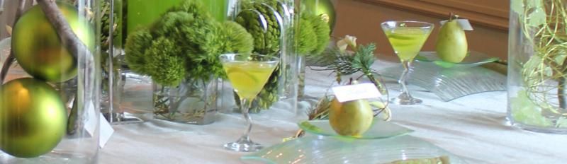 Green cocktails and limes on a mirrored table with a bright, elegant setting