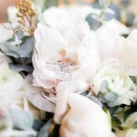 Soft pastel floral bouquet with white and blush flowers and green eucalyptus leaves