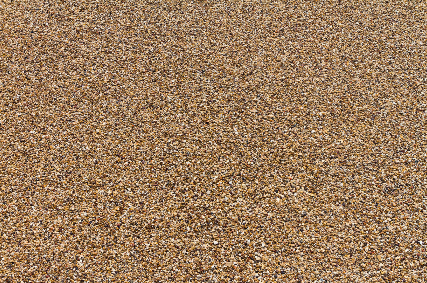 A close up of a pile of small stones and dirt on the ground.