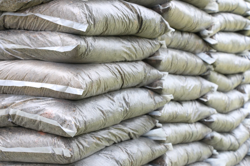 A pile of topsoil bags stacked on top of each other.