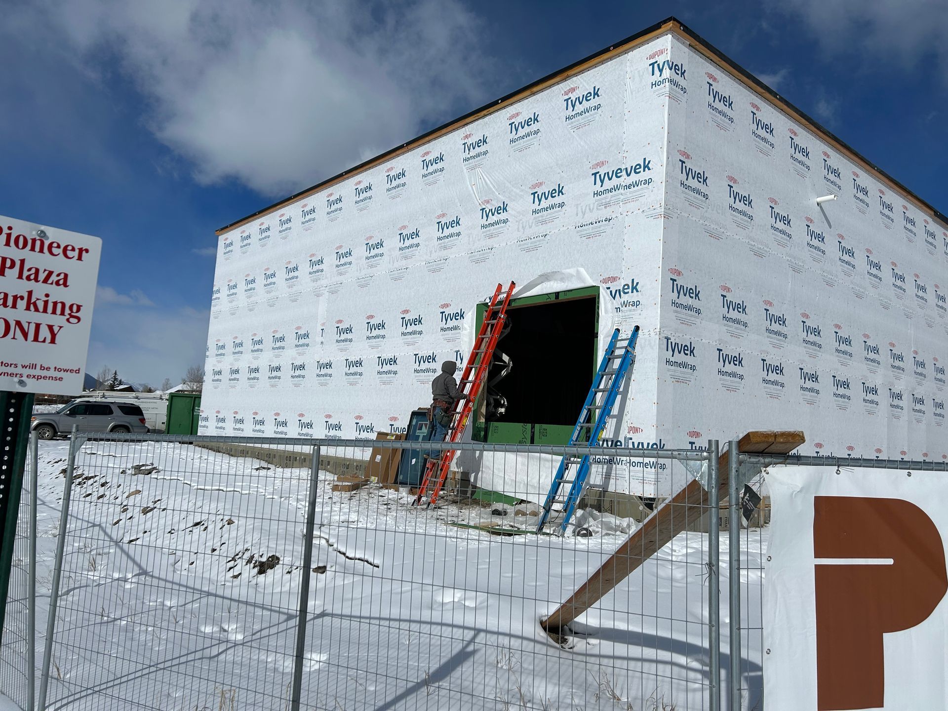 A building under construction with a sign that says reindeer pizza parking only