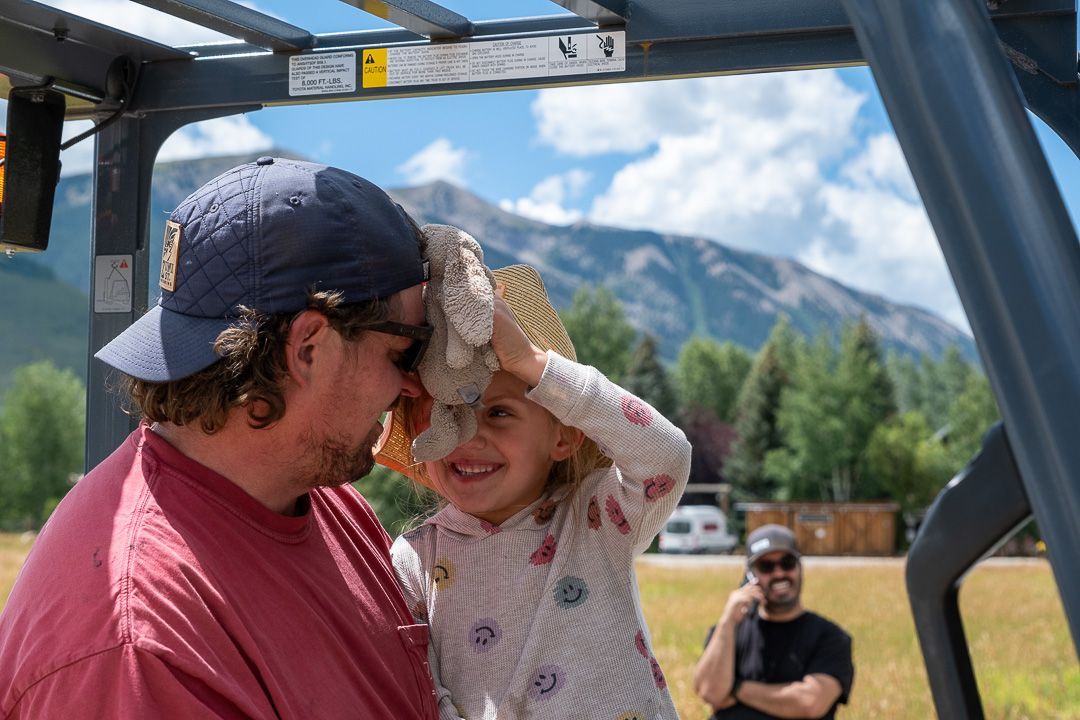 A man and a little girl are sitting in a vehicle.