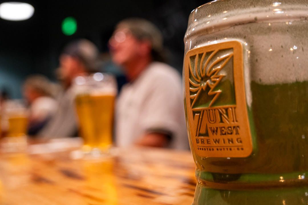 A bottle of zini west brewing beer on a table