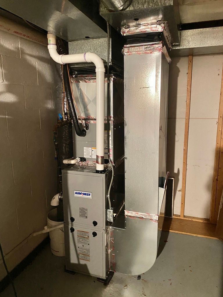 Basement furnace and ductwork with insulated vent pipe and utility closet walls