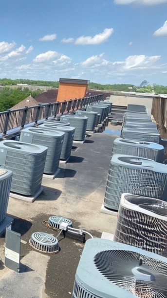 Full Time Heating & Cooling | There are a lot of air conditioners on the roof of a building.