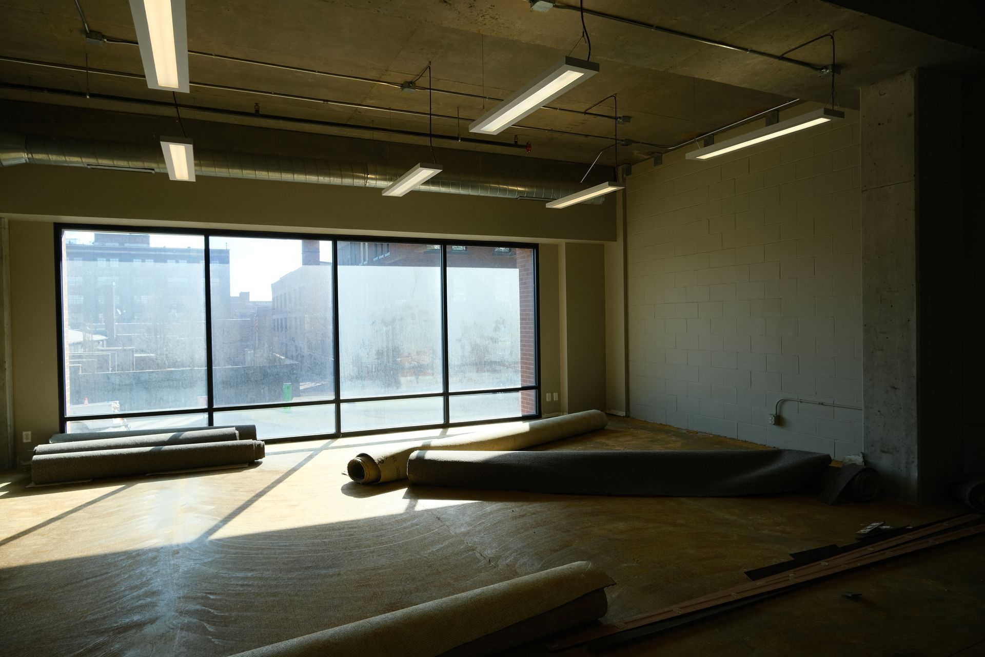 A large empty room with a lot of windows