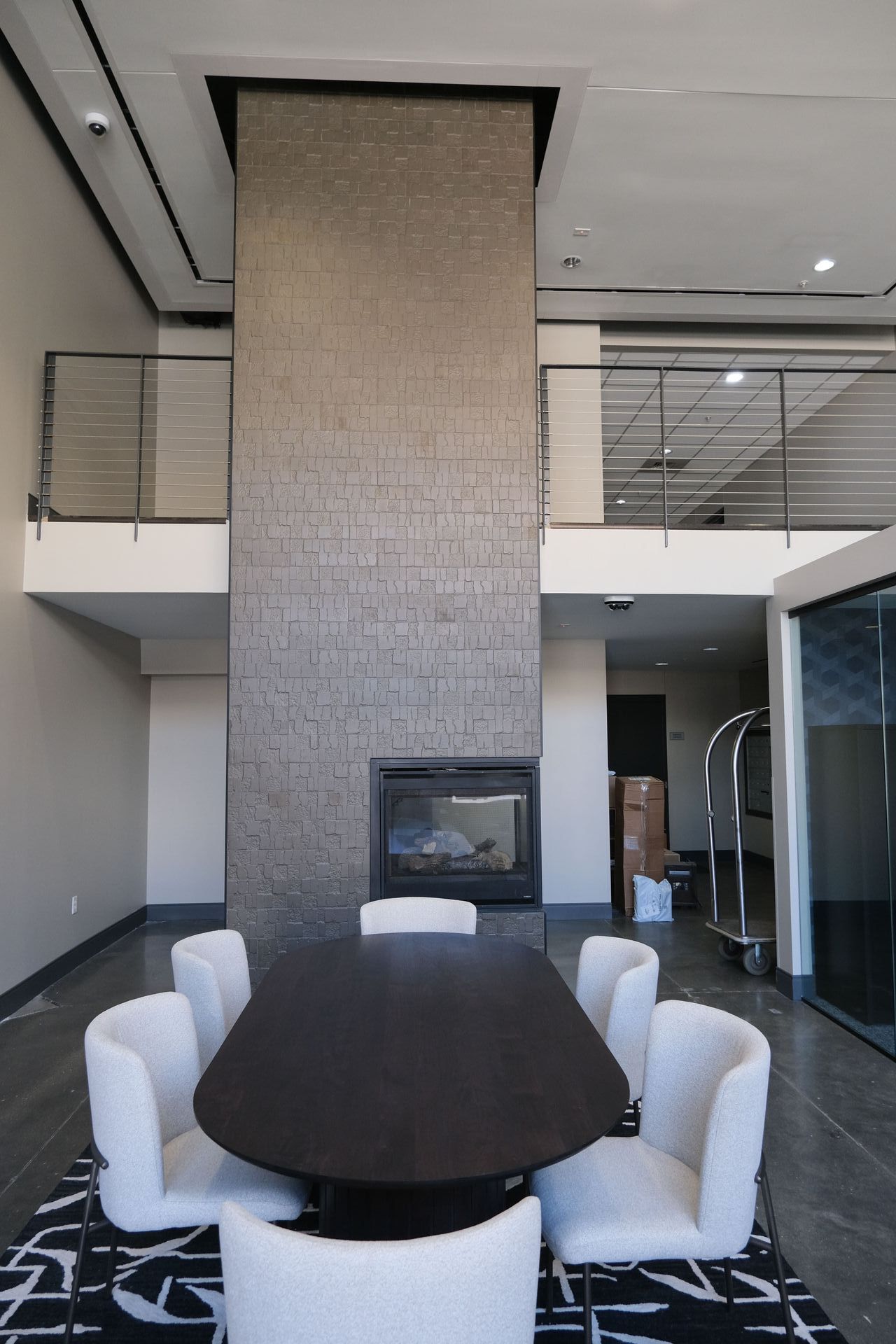 A room with a table and chairs and a fireplace
