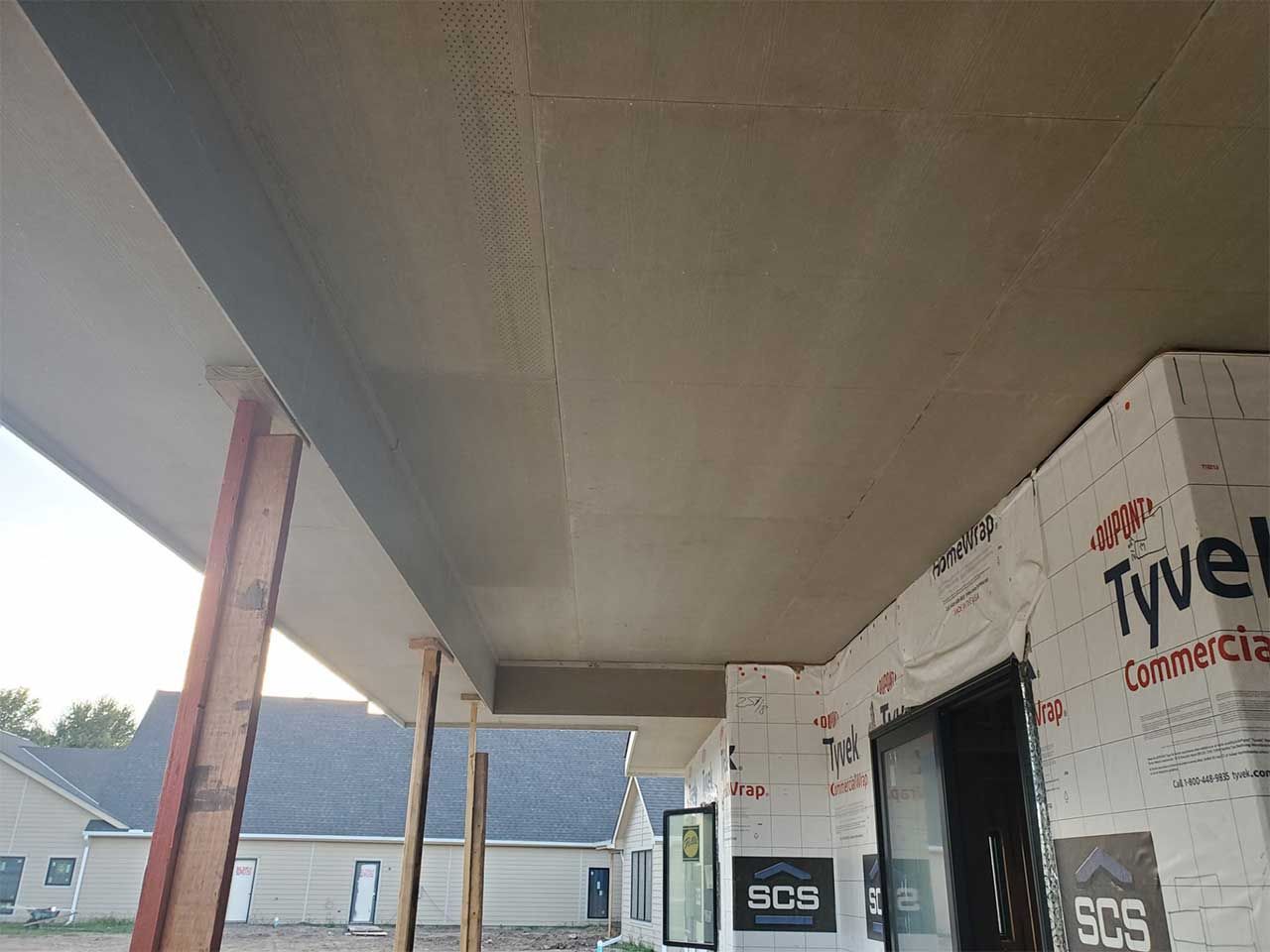 A building under construction with a roof that is being built.