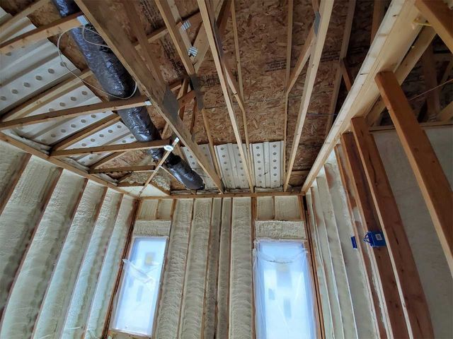 A room with a lot of wooden beams and a ceiling.
