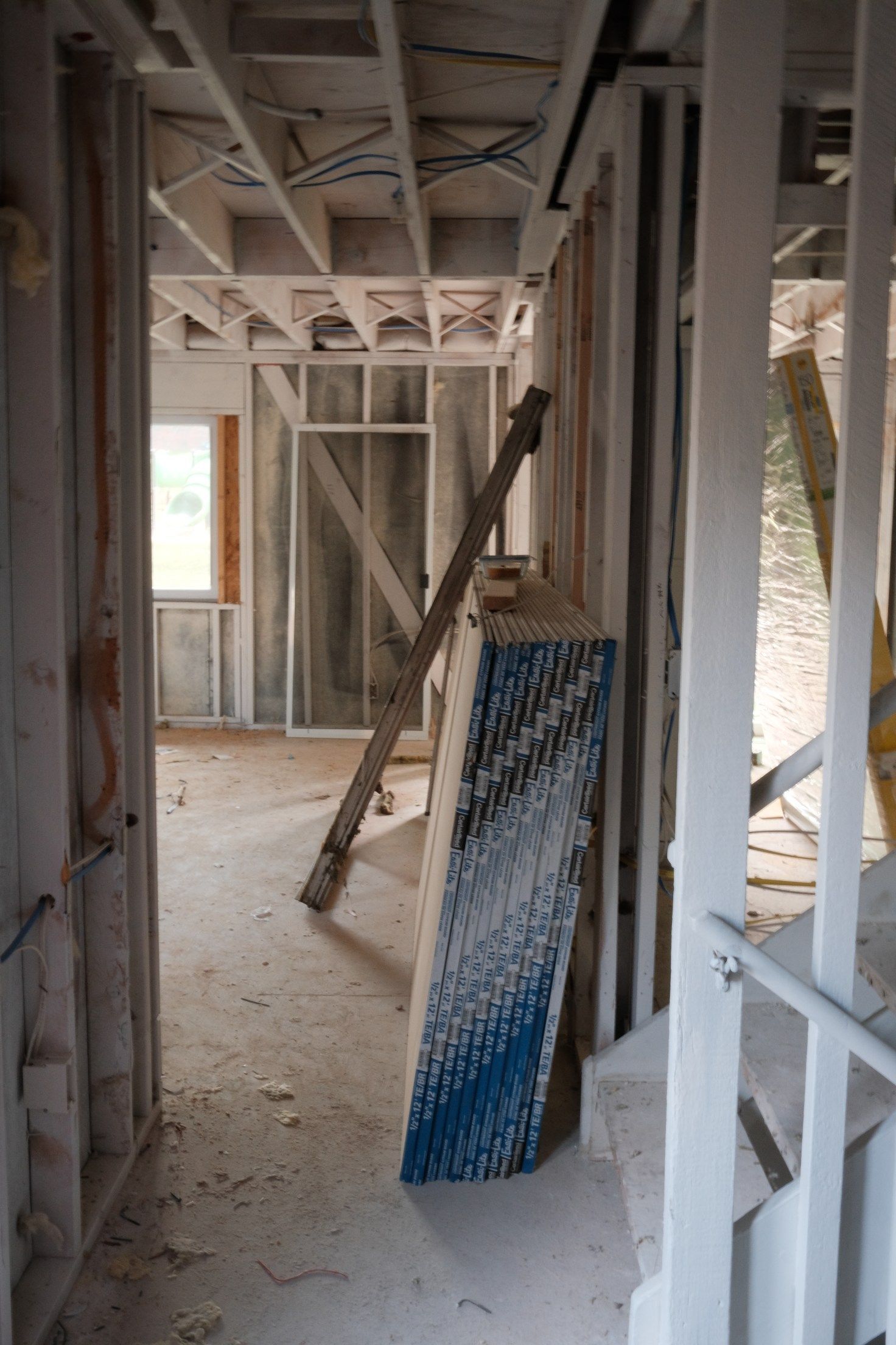 Interior of a building under construction; wooden frames, hallway, and unfinished walls.