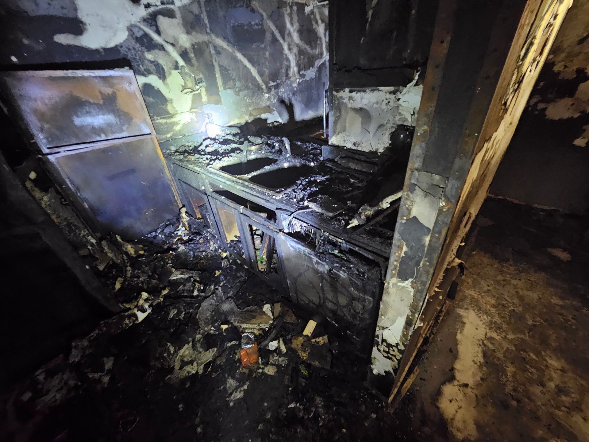 A kitchen that has been damaged by a fire.