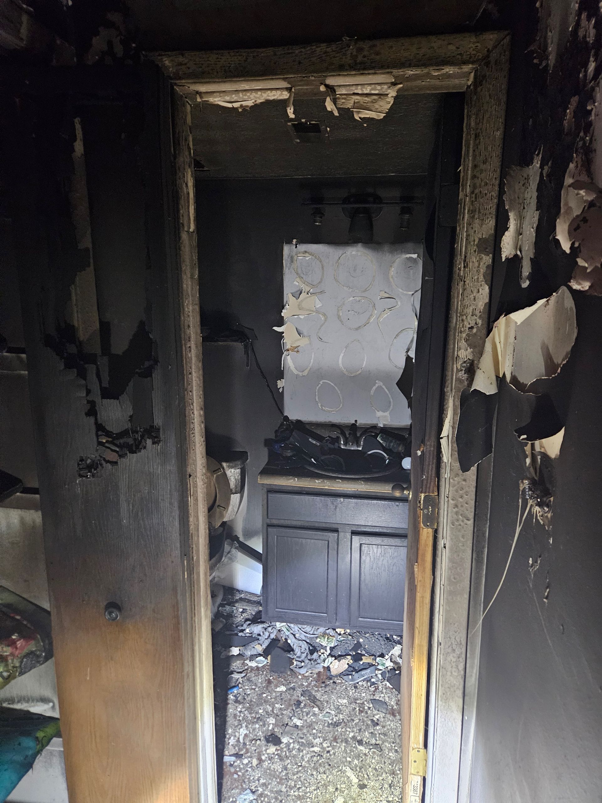 A doorway leading to a kitchen with a stove and cabinets.