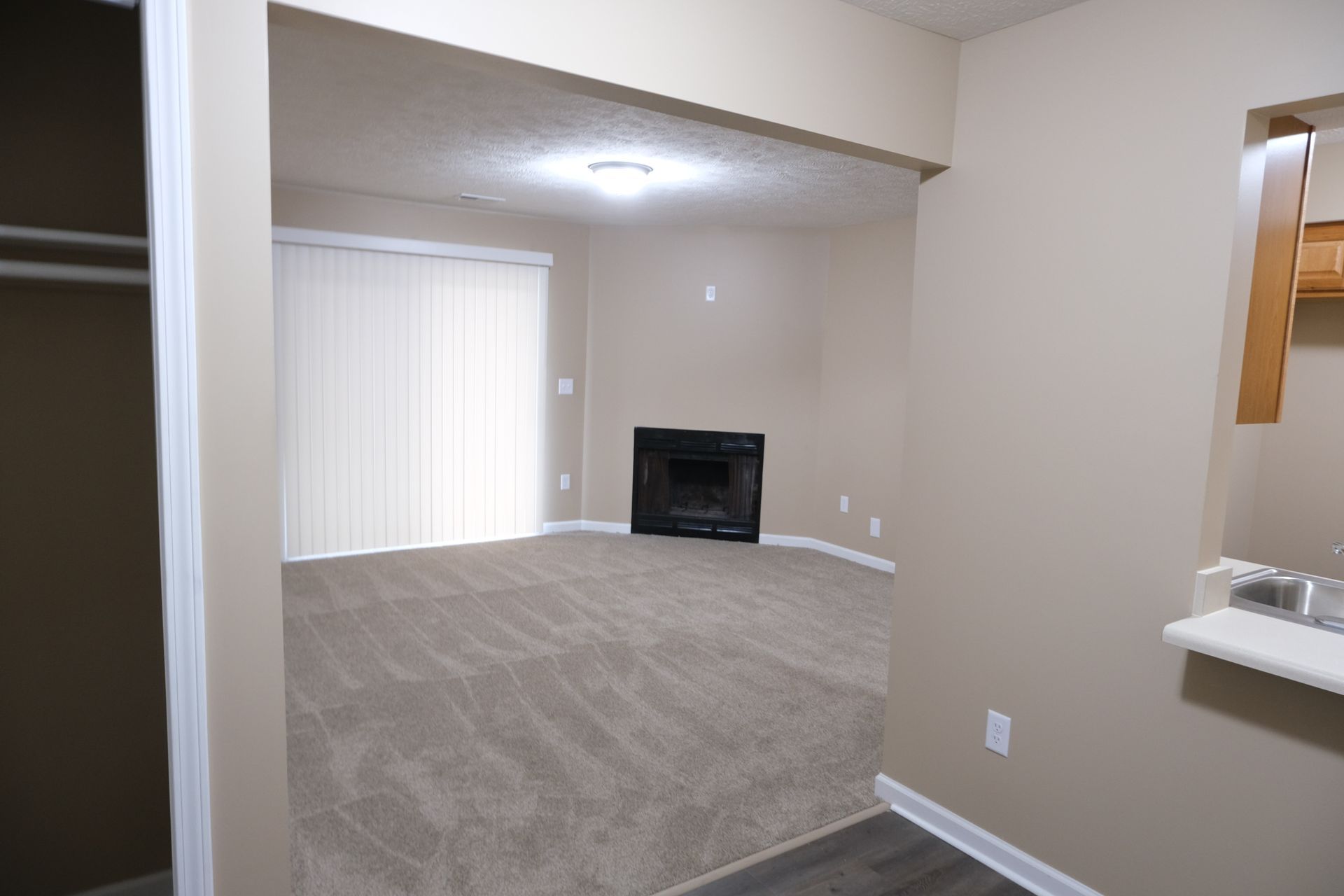 There is a fireplace in the middle of the living room.