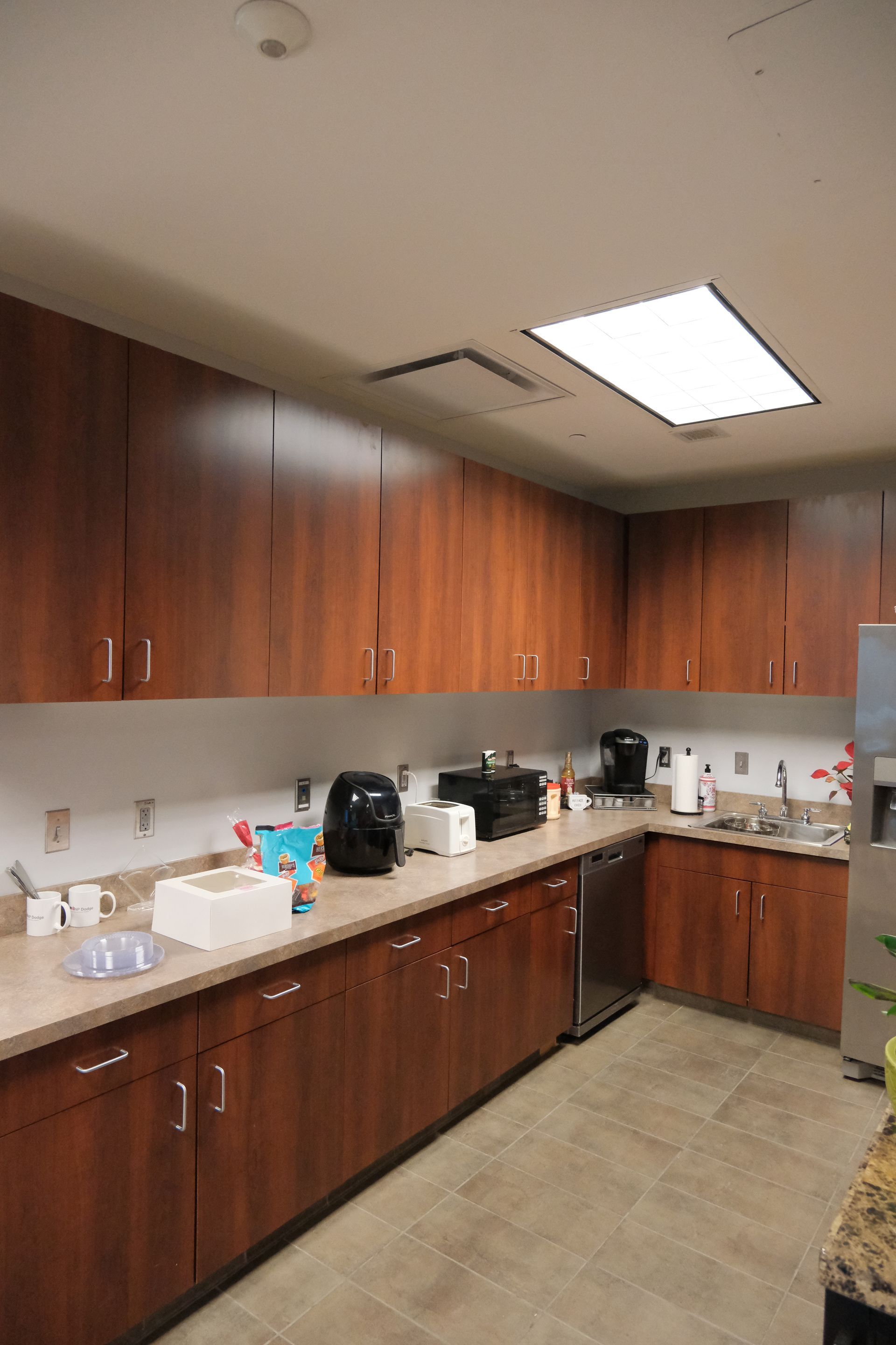 A kitchen with wooden cabinets and stainless steel appliances