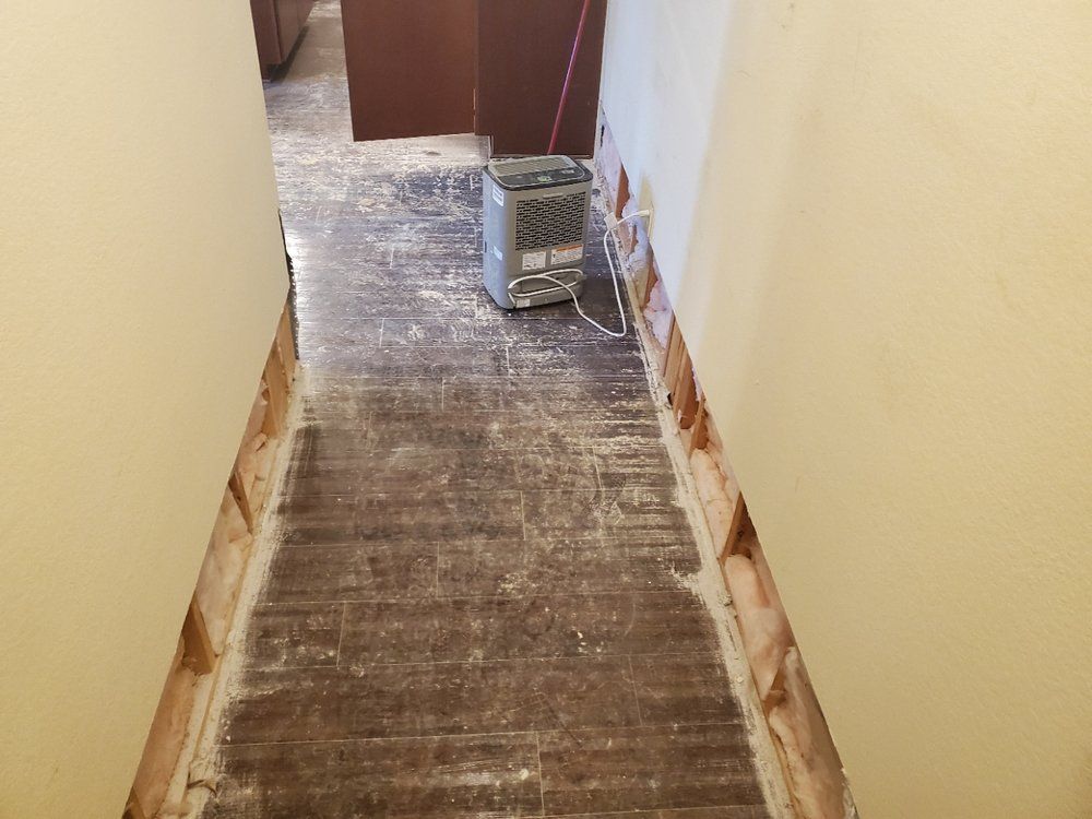 A hallway with a heater sitting on the floor.