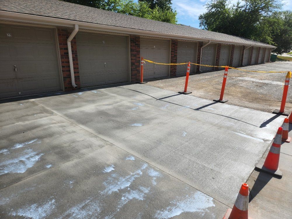 A row of garage doors are lined up in a parking lot.