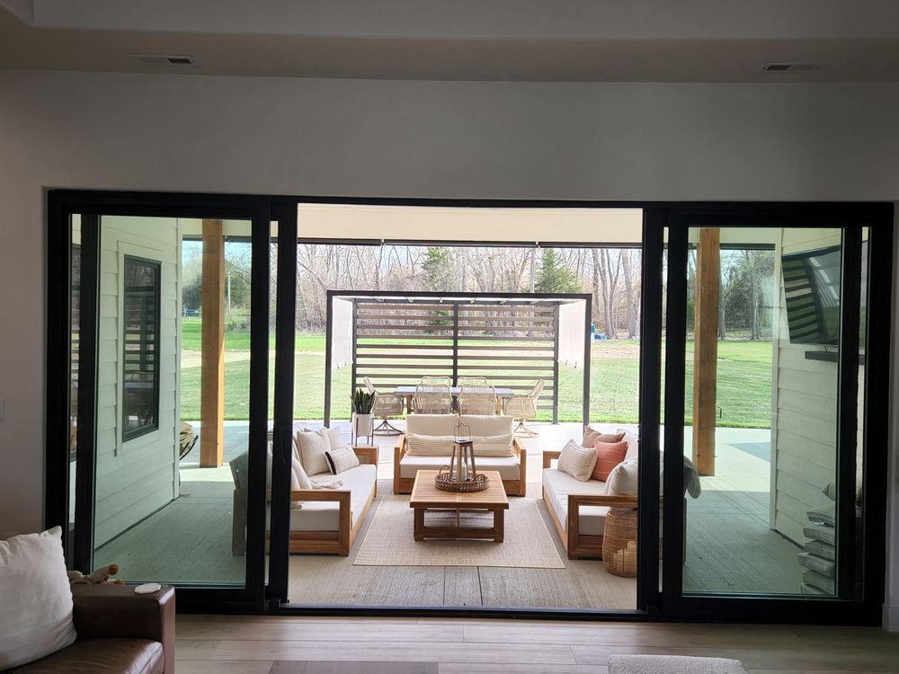 A living room with sliding glass doors leading to a patio.