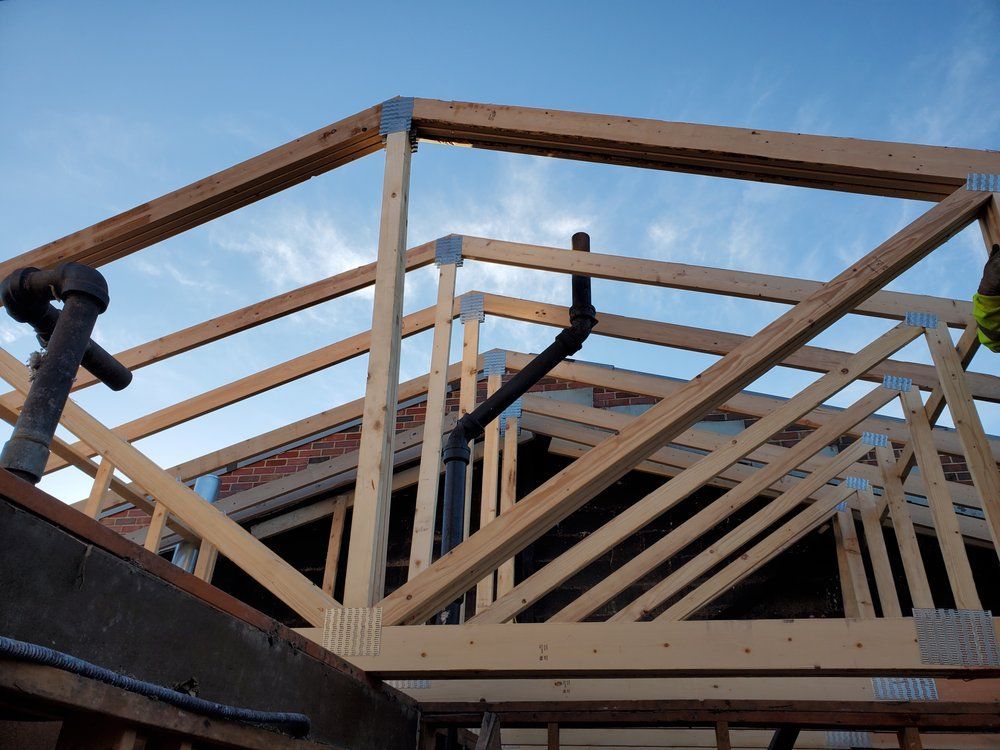 A wooden structure is being built on top of a building.