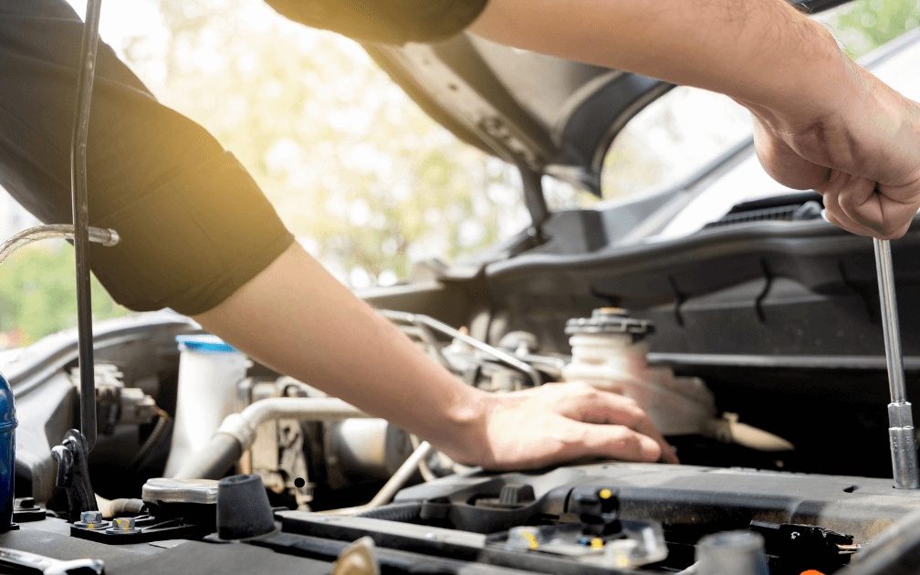 two mechanics performing routine car maintenance