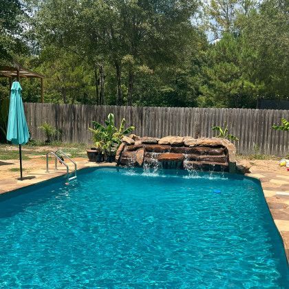 There is a waterfall in the middle of the pool.