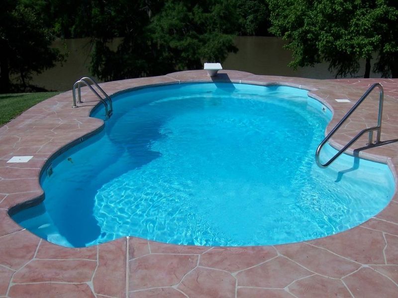 A large swimming pool with a staircase leading to it