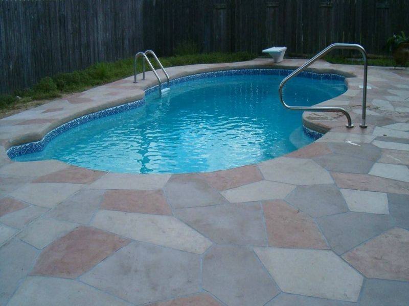 A large swimming pool with stairs leading to it