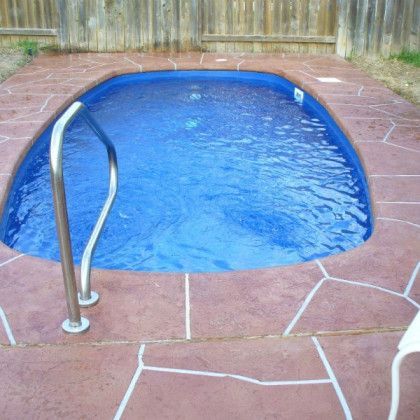A small swimming pool with a staircase leading to it