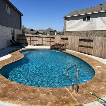 A large swimming pool in the backyard of a house