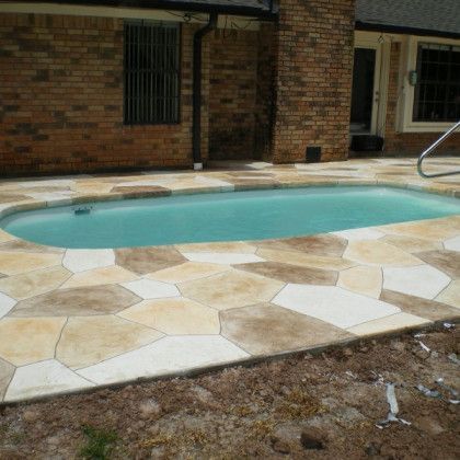 A brick house with a swimming pool in front of it
