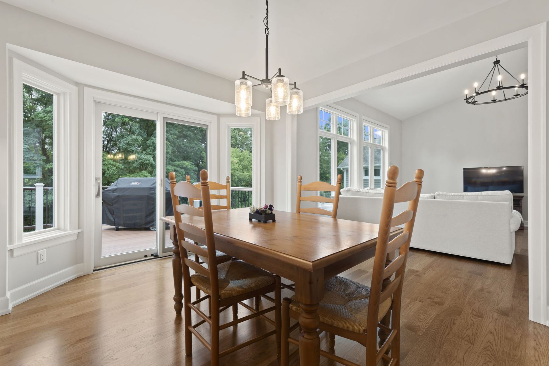 Breakfast nook with bay windows and a sliding door to the deck, open to the family room.