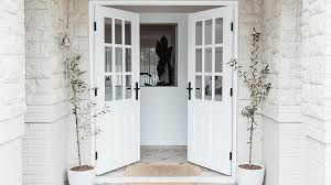 Modern white entrance doors with double glazed glass panels, adding style and insulation to the home exterior.