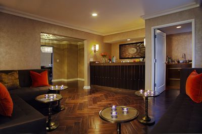 A living room with a couch , tables and candles.