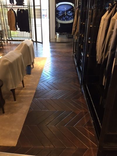 A store with a herringbone floor and a clock on the wall