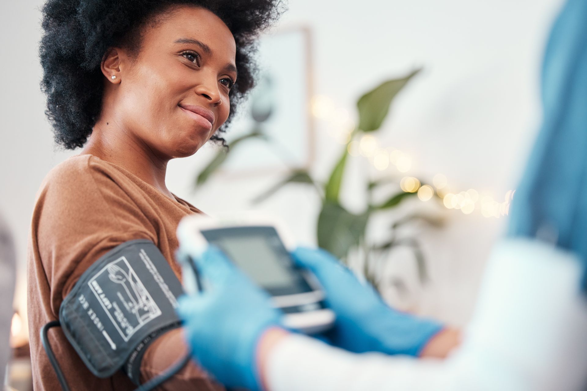 A person has their blood pressure taken by a medical professional.