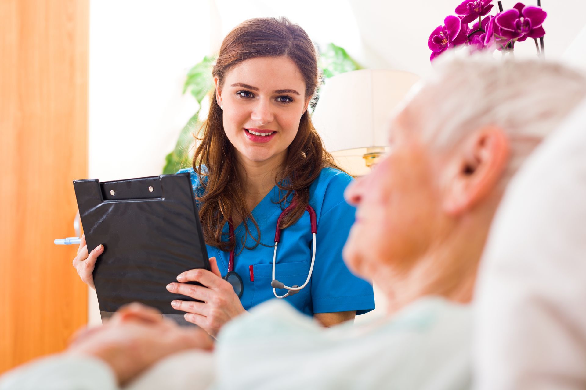 Doctor in white coat reviewing medical chart with patient.