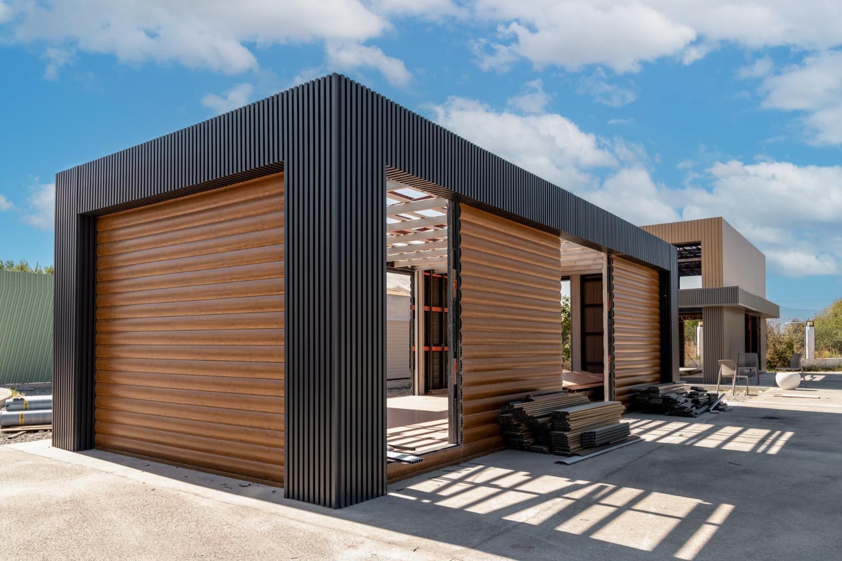 A building under construction with a wooden roof and a metal roof.